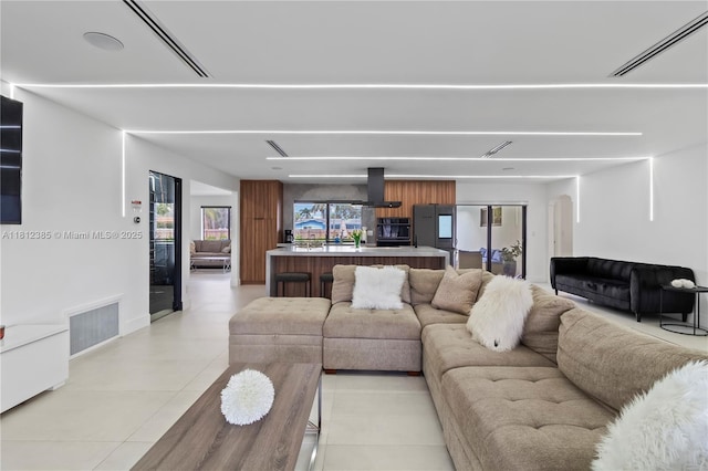 5131 Monroe St, Hollywood, FL 33021 - living room featuring light tile patterned flooring, arched walkways, and baseboards