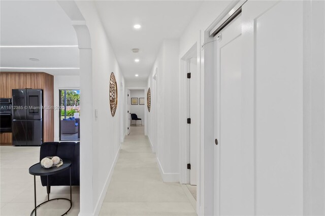5131 Monroe St, Hollywood, FL 33021 - hallway featuring recessed lighting, arched walkways, baseboards, and light tile patterned flooring