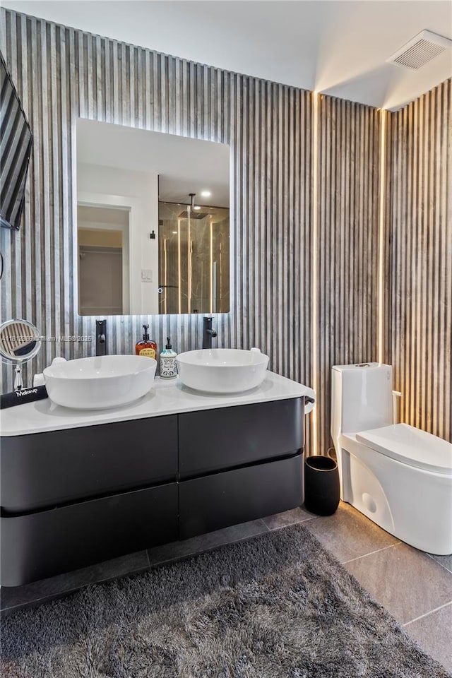 5131 Monroe St, Hollywood, FL 33021 - full bath featuring wallpapered walls, double vanity, a shower stall, toilet, and tile patterned floors