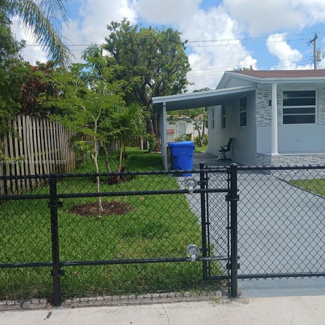 6421 Allen St, Hollywood, FL 33024 - view of side of home with a carport, a gate, and stucco siding