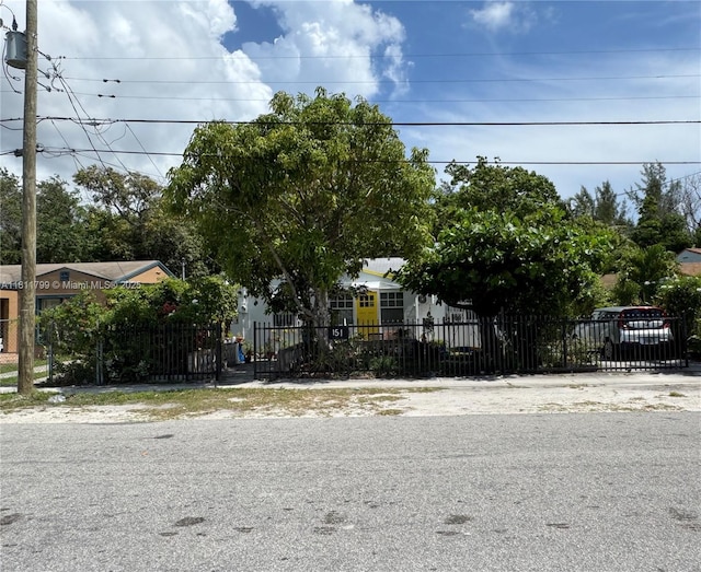 151 NW 64th St, Miami, FL 33150 - view of property hidden behind natural elements featuring a fenced front yard