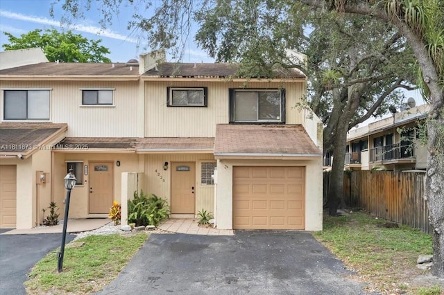 4225 N 76th Ave, Davie, FL 33024 - view of property featuring a shingled roof, a garage, and asphalt driveway