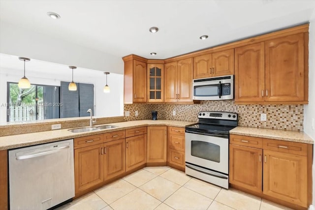 4225 N 76th Ave, Davie, FL 33024 - kitchen featuring appliances with stainless steel finishes, a sink, tasteful backsplash, glass insert cabinets, and pendant lighting