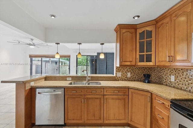 4225 N 76th Ave, Davie, FL 33024 - kitchen featuring stainless steel dishwasher, a sink, light stone countertops, and brown cabinets