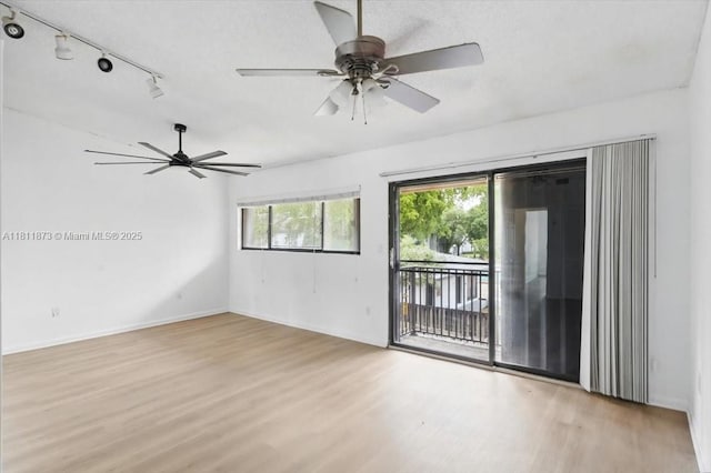 4225 N 76th Ave, Davie, FL 33024 - empty room featuring light wood-style flooring, a ceiling fan, baseboards, and track lighting