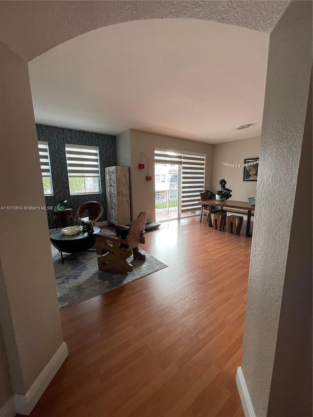 8980 W Flagler St Unit 202, Miami, FL 33174 - living area with wood finished floors, healthy amount of natural light, baseboards, and a textured wall