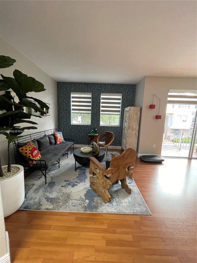 8980 W Flagler St Unit 202, Miami, FL 33174 - living room with an accent wall, wood finished floors, plenty of natural light, wallpapered walls, and baseboards