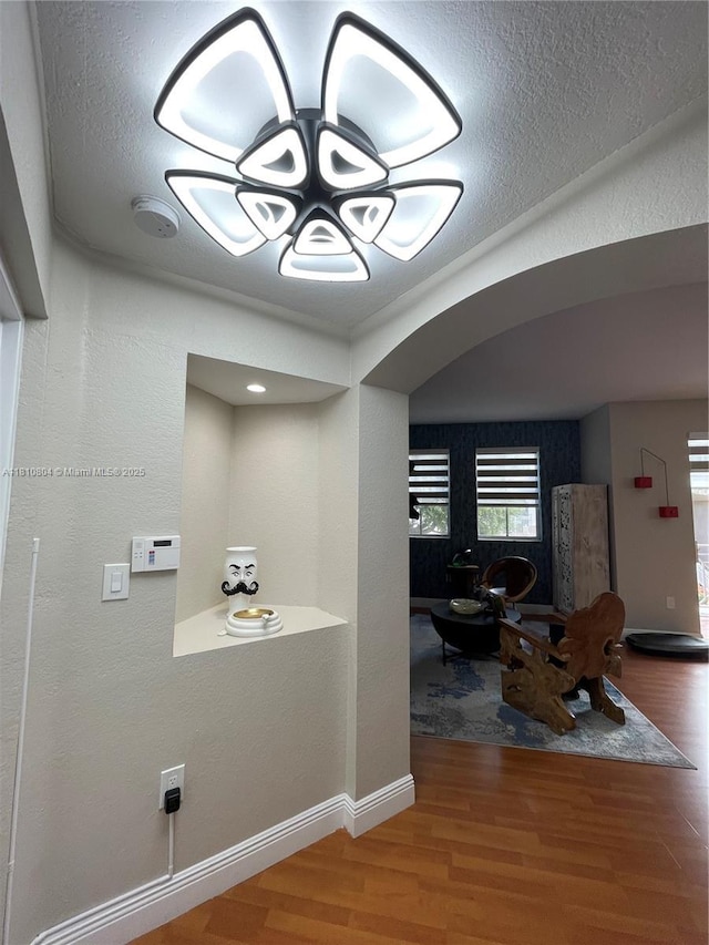 8980 W Flagler St Unit 202, Miami, FL 33174 - corridor featuring wood finished floors, a textured wall, baseboards, and a textured ceiling