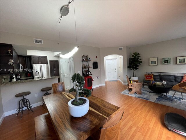 8980 W Flagler St Unit 202, Miami, FL 33174 - dining room with arched walkways, wood finished floors, and baseboards