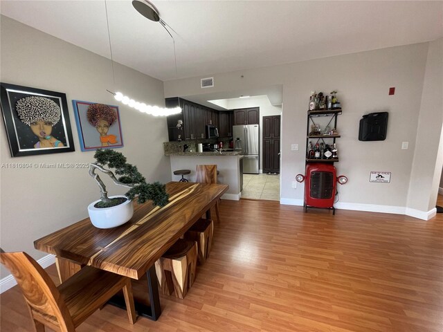 8980 W Flagler St Unit 202, Miami, FL 33174 - dining space with light wood-style flooring and baseboards