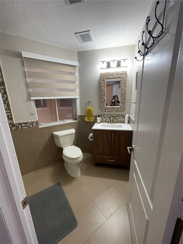 8980 W Flagler St Unit 202, Miami, FL 33174 - bathroom with tile walls, tile patterned floors, toilet, vanity, and a textured ceiling