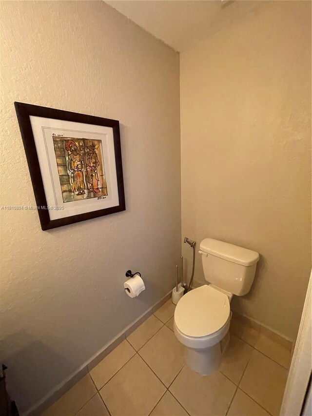 8980 W Flagler St Unit 202, Miami, FL 33174 - bathroom featuring toilet, tile patterned floors, and baseboards