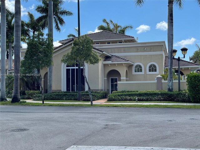 8980 W Flagler St Unit 202, Miami, FL 33174 - view of front of house with a tile roof and stucco siding