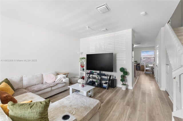 9214 W 33rd Ln, Hialeah, FL 33018 - living room featuring light wood-style floors and baseboards