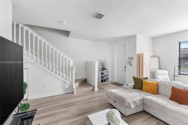 9214 W 33rd Ln, Hialeah, FL 33018 - living room with stairway, light wood finished floors, and baseboards