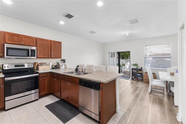 9214 W 33rd Ln, Hialeah, FL 33018 - kitchen with appliances with stainless steel finishes, a sink, a peninsula, light countertops, and recessed lighting
