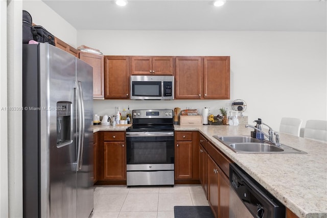9214 W 33rd Ln, Hialeah, FL 33018 - kitchen featuring stainless steel appliances, light tile patterned floors, light countertops, a peninsula, and a sink