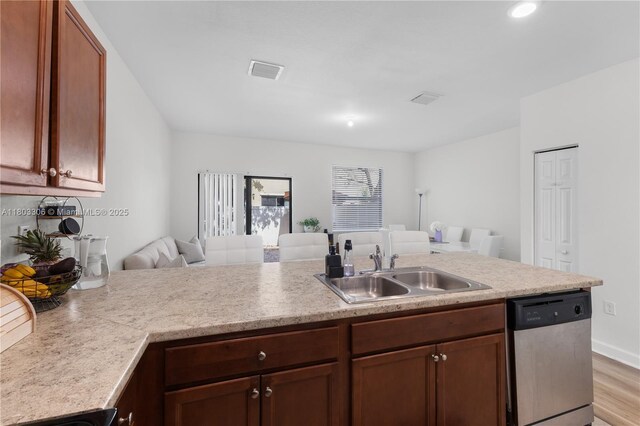 9214 W 33rd Ln, Hialeah, FL 33018 - kitchen with stainless steel dishwasher, open floor plan, a sink, light countertops, and light wood finished floors