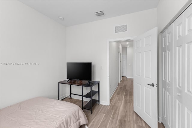 9214 W 33rd Ln, Hialeah, FL 33018 - bedroom with light wood-style floors, a closet, and baseboards