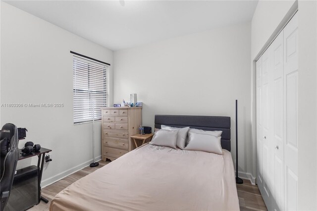 9214 W 33rd Ln, Hialeah, FL 33018 - bedroom featuring wood finished floors, a closet, and baseboards