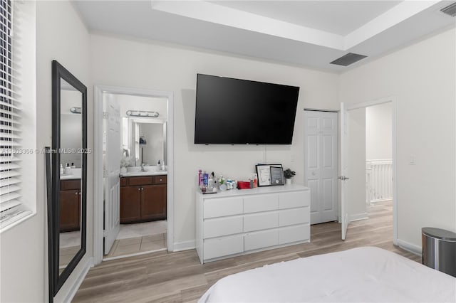 9214 W 33rd Ln, Hialeah, FL 33018 - bedroom featuring light wood finished floors, ensuite bath, and baseboards
