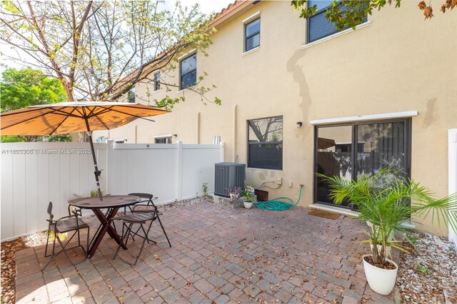 9214 W 33rd Ln, Hialeah, FL 33018 - view of patio with central AC and outdoor dining area
