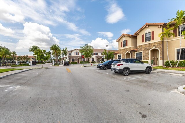 9214 W 33rd Ln, Hialeah, FL 33018 - view of asphalt street featuring a residential view, street lights, traffic signs, and curbs