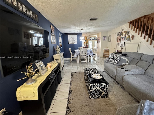 10428 NW 3rd St, Pembroke Pines, FL 33026 - living area featuring light tile patterned floors, a textured ceiling, and stairway