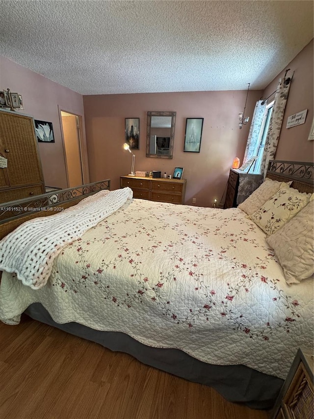 10428 NW 3rd St, Pembroke Pines, FL 33026 - bedroom featuring a textured ceiling and wood finished floors