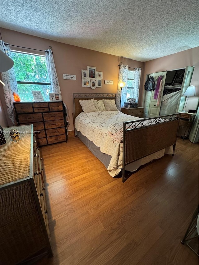 10428 NW 3rd St, Pembroke Pines, FL 33026 - bedroom featuring multiple windows, wood finished floors, and a textured ceiling
