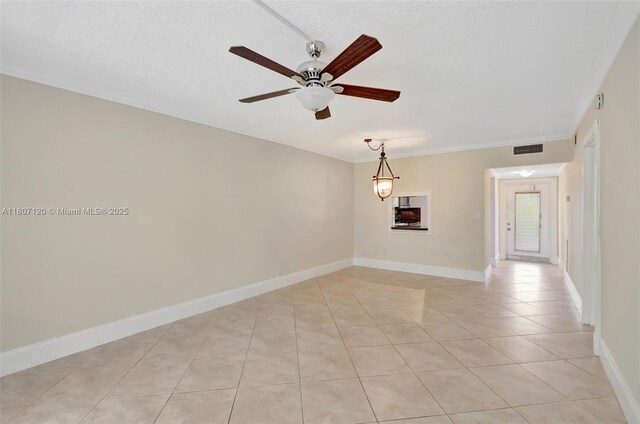 1055 Country Club Dr Unit 406, Margate, FL 33063 - spare room featuring ceiling fan, light tile patterned flooring, a textured ceiling, crown molding, and baseboards