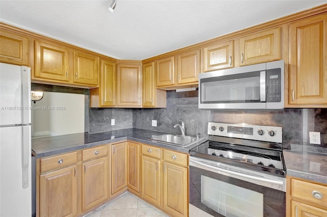 1055 Country Club Dr Unit 406, Margate, FL 33063 - kitchen featuring stainless steel appliances, a sink, light tile patterned floors, and decorative backsplash