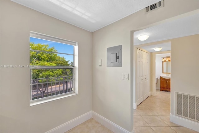 1055 Country Club Dr Unit 406, Margate, FL 33063 - corridor featuring electric panel, baseboards, light tile patterned flooring, and a sink