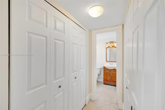 1055 Country Club Dr Unit 406, Margate, FL 33063 - corridor with light tile patterned floors and a textured ceiling
