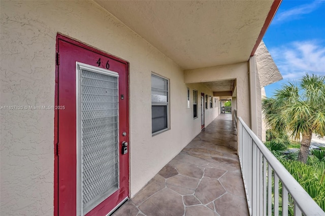 1055 Country Club Dr Unit 406, Margate, FL 33063 - doorway to property featuring a balcony and stucco siding