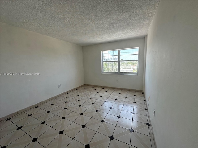 1130 11th St Unit 4J, Miami Beach, FL 33139 - spare room with a textured ceiling and baseboards