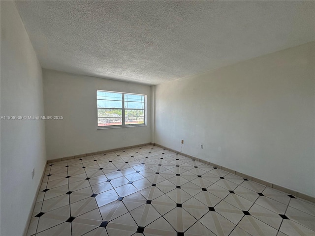 1130 11th St Unit 4J, Miami Beach, FL 33139 - spare room with a textured ceiling and baseboards