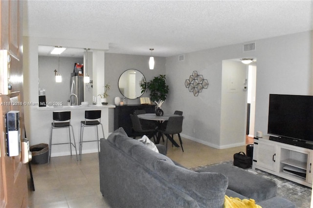 3586 N University Dr Unit U-6, Coral Springs, FL 33065 - tiled living area featuring a textured ceiling and baseboards