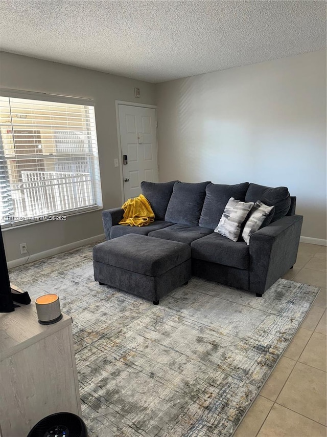 3586 N University Dr Unit U-6, Coral Springs, FL 33065 - living area with light tile patterned flooring, a textured ceiling, and baseboards