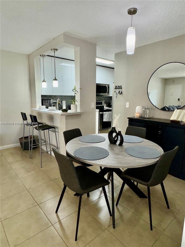 3586 N University Dr Unit U-6, Coral Springs, FL 33065 - dining area featuring light tile patterned floors and a textured ceiling