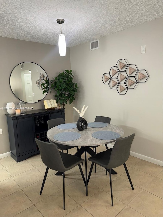 3586 N University Dr Unit U-6, Coral Springs, FL 33065 - dining room featuring a textured ceiling, light tile patterned flooring, and baseboards