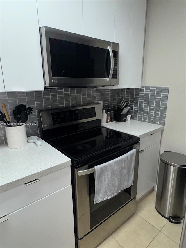 3586 N University Dr Unit U-6, Coral Springs, FL 33065 - kitchen featuring stainless steel appliances, white cabinetry, and decorative backsplash