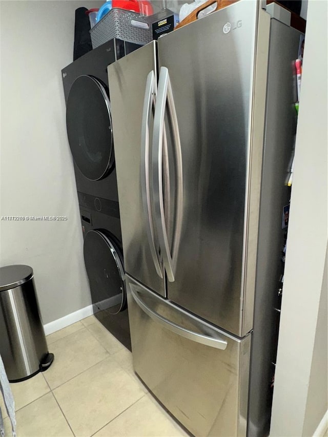 3586 N University Dr Unit U-6, Coral Springs, FL 33065 - washroom with stacked washer and clothes dryer, light tile patterned flooring, and baseboards