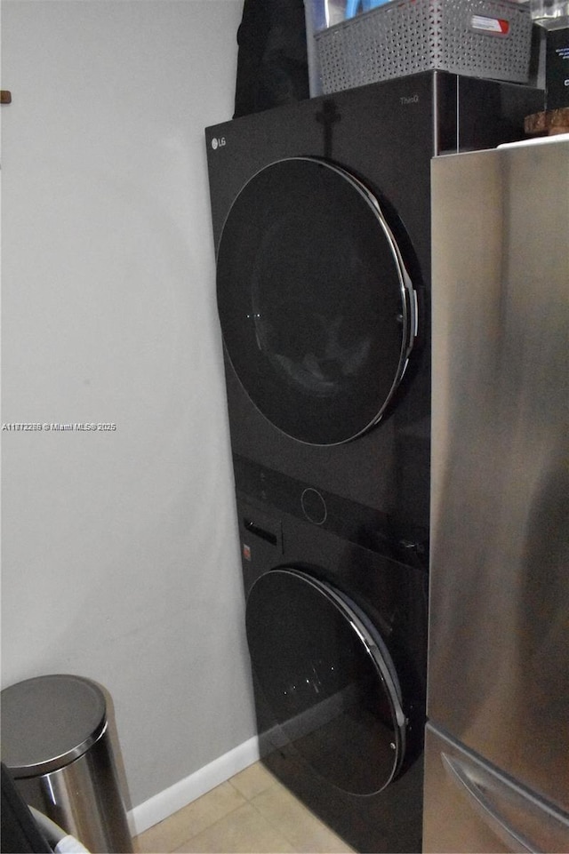 3586 N University Dr Unit U-6, Coral Springs, FL 33065 - laundry area featuring stacked washing machine and dryer and baseboards