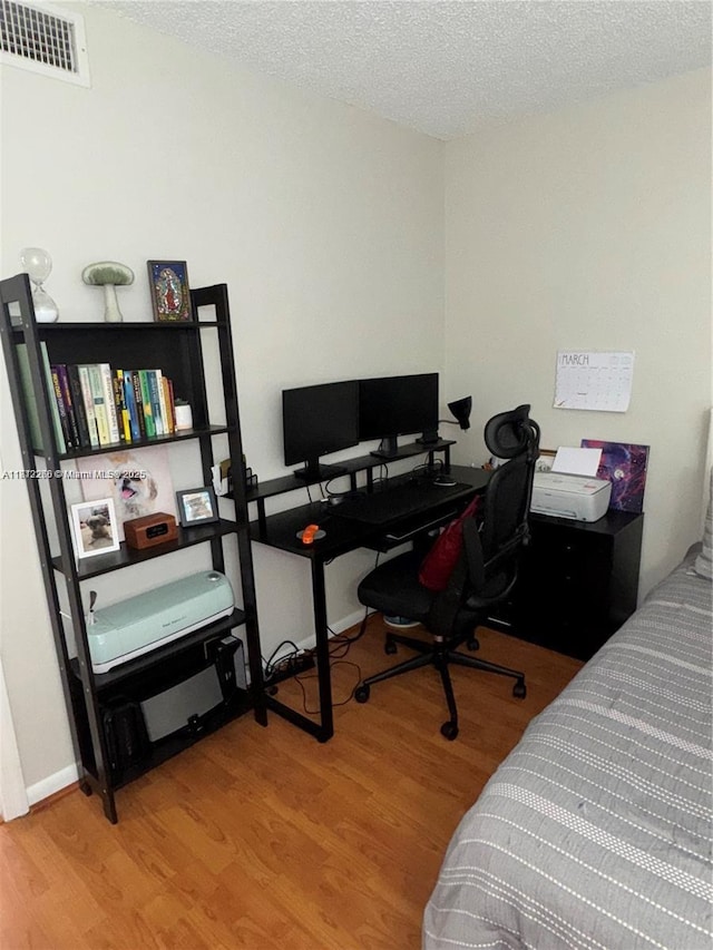 3586 N University Dr Unit U-6, Coral Springs, FL 33065 - bedroom featuring wood finished floors, a textured ceiling, and a desk