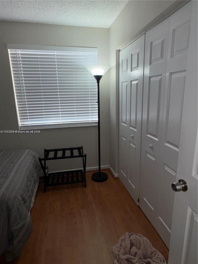3586 N University Dr Unit U-6, Coral Springs, FL 33065 - bedroom with wood finished floors, a textured ceiling, and a closet