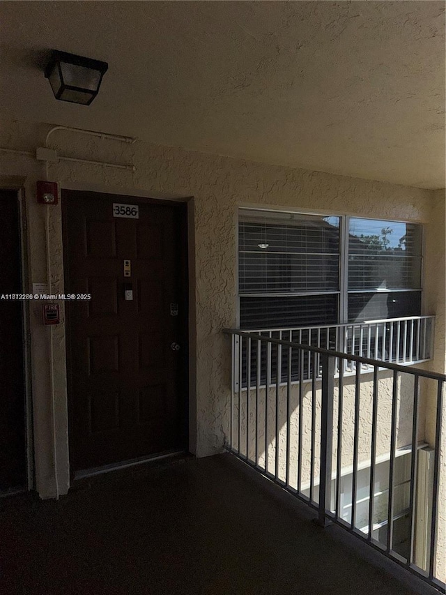 3586 N University Dr Unit U-6, Coral Springs, FL 33065 - view of exterior entry with a balcony and stucco siding