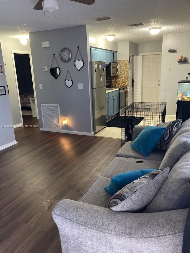 6132 SW 39th St, Miramar, FL 33023 - living room with a textured ceiling, wood finished floors, baseboards, and water heater