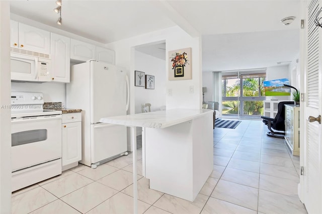 2801 N Pine Island Rd Unit 204, Sunrise, FL 33322 - kitchen with white appliances, white cabinets, a peninsula, and light tile patterned floors
