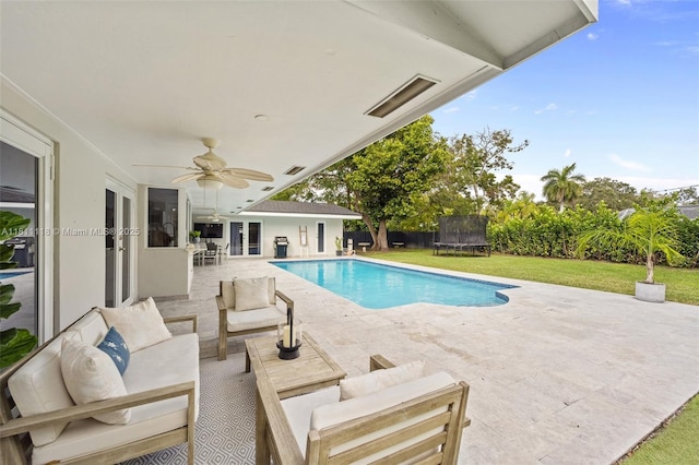17243 SW 87th Ave, Palmetto Bay, FL 33157 - view of swimming pool with a trampoline, a patio area, a yard, outdoor lounge area, and ceiling fan